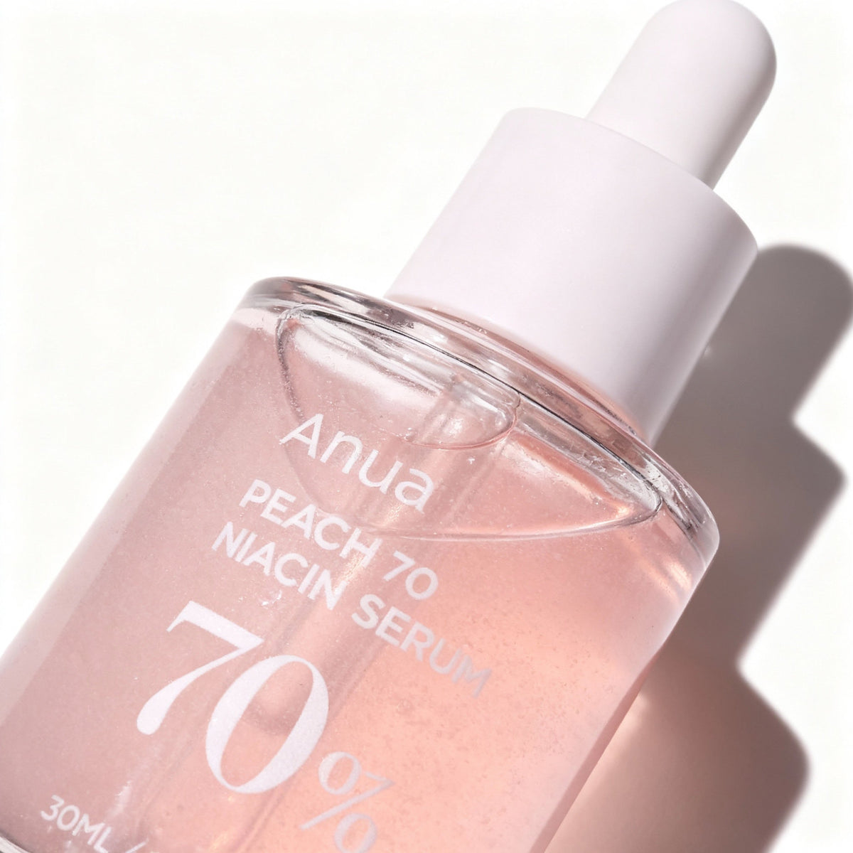 Macro close-up of the PeachGlow Body Serum bottle