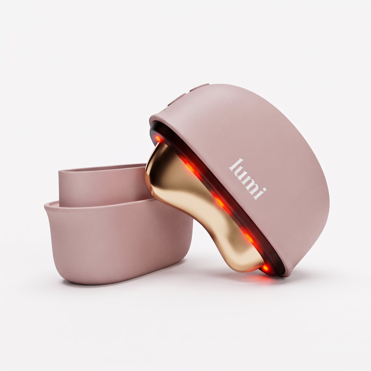 Lumi Ember heated gua sha facial massager in rosé with polished gold-tone head and protective cover on a white background