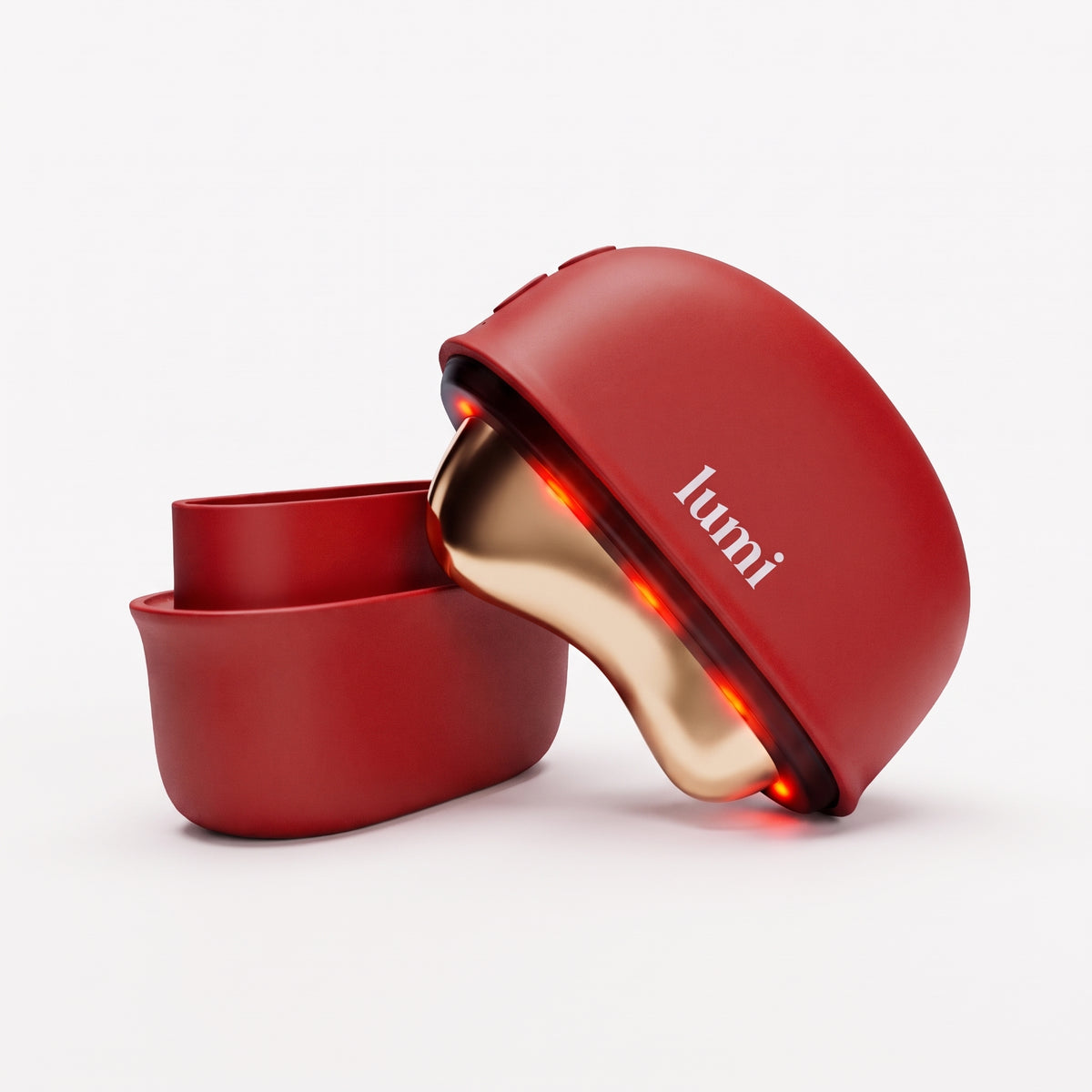 Lumi Ember heated gua sha facial massager in ruby red with matching protective cover on a white background